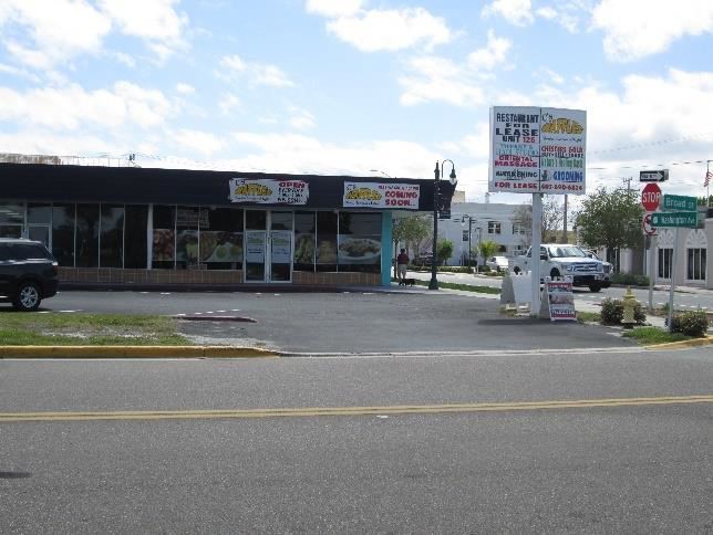 Photo of a restaurant in a small strip mall.