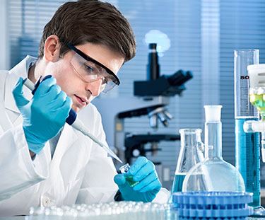guy in lab with beakers