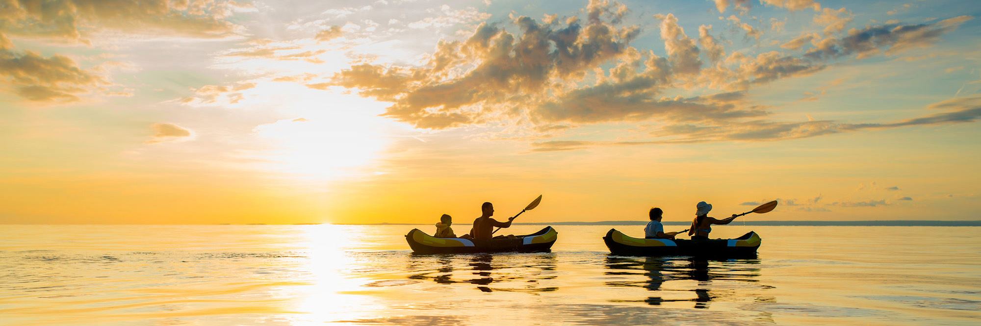 people kayaking at sunset